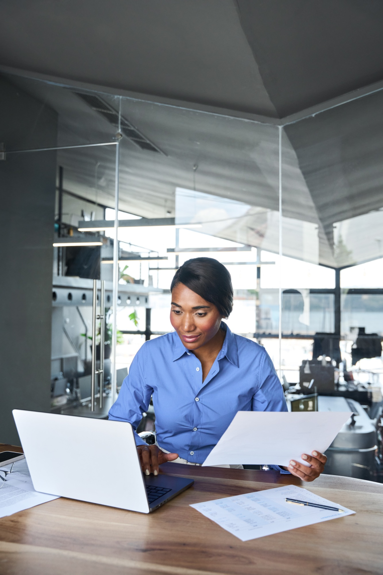 busy-young-african-american-business-woman-holding-papers-using-laptop-1-1